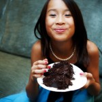 The flower girl enjoys rehearsing the cake!
